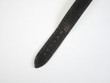 a black watch that is laying on a white surface