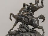 bronze statue of a man riding a horse with a woman on it