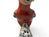 a figurine of a bird that is sitting on a rock