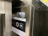 an image of a stainless steel elevator with a button