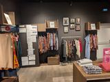 a photo of a clothing store with clothes on display