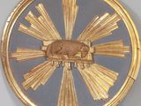 a gold clock with a picture of a dog on it
