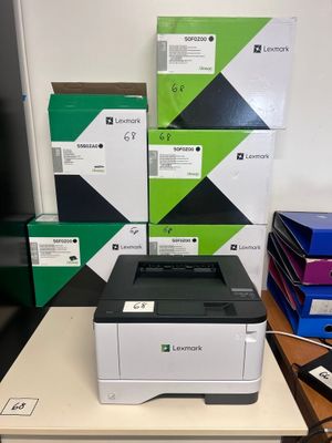 a printer sitting on top of a table next to a stack of boxes