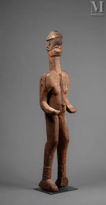 an image of a wooden statue of a man holding a knife