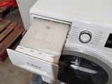 a white washer sitting in the middle of a room
