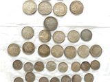 Plusieurs pièces de monnaie sont disposées sur une feuille de papier posée sur une surface blanche.