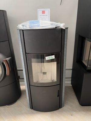 two black stoves sitting next to each other on the floor