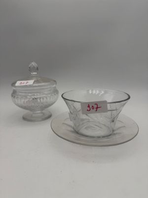 two glass bowls and a saucer on a plate with a price tag