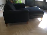 a black chair and a black ottoman in a living room