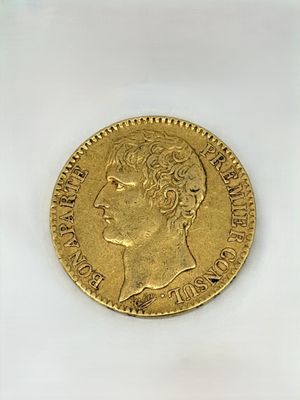 a close up of a gold coin on a white surface