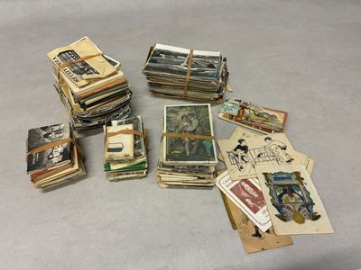 a pile of old cards and postcards on a table