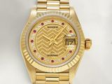 an image of a gold wrist watch with diamonds on the dial