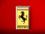 a ferrari badge on a red background