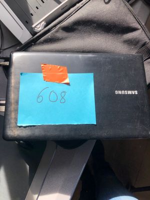 a laptop with a note taped to it sitting on a desk