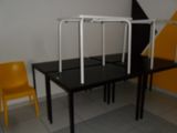 a black table with a yellow chair and a yellow chair