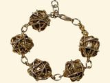 a bracelet made of metal balls on a chain