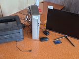 a desk with a computer, printer, mouse, and a monitor