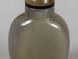 a small glass jar with a lid on a table