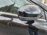 a reflection of a person in a mirror on the side mirror of a car