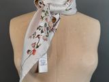 a close up of a mannequin torso with a white scarf on it