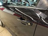 a close up of a car door handle with a sticker on it