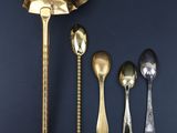 five spoons and two spoon spoons on a table