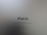 an apple ipad air is sitting on a wooden table