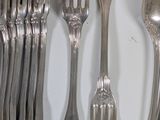 a lot of forks and spoons that are on the table