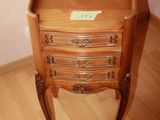 a small wooden table with a drawer on top of it