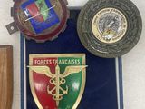 three medals and a plaque are on display in a case