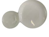 a white bowl with a lid sitting on a white surface