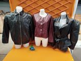 three mannequins dressed in leather jackets on display