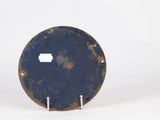 a blue plate with a hole in it on a white surface