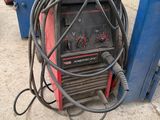a welding machine that is sitting on the ground