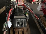 a small engine sitting on a pallet in a warehouse
