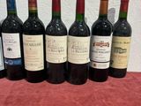 several bottles of wine are lined up on a table