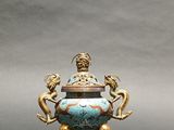 an image of a statue of a man sitting on top of a vase