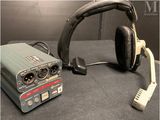 a pair of headphones on a table next to a microphone and headphone