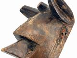 a close up of a wooden mask on a white background