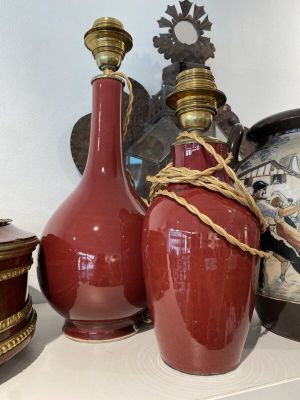 three vases sitting on a shelf with a clock in the background