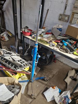 an image of a garage with a lot of junk on the floor
