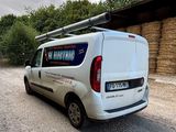 a van that is parked in front of a hay bale