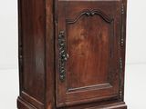 an old wooden cabinet with a door on top of it
