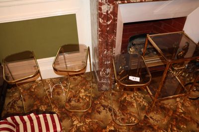 two chairs and a table in front of a fire place