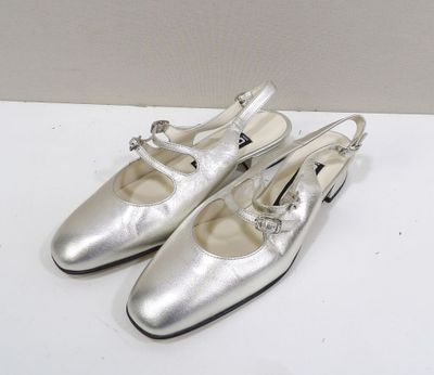 silver leather shoes with buckles on the toes and heel