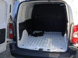 a white van that has a bed in the back of it