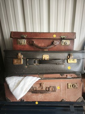 several pieces of luggage stacked on top of each other in a room
