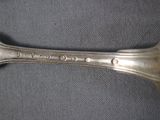 a silver spoon that is sitting on a table
