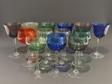 many different colored wine glasses lined up on a table