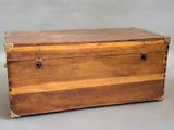 a small wooden box with a metal latch on it